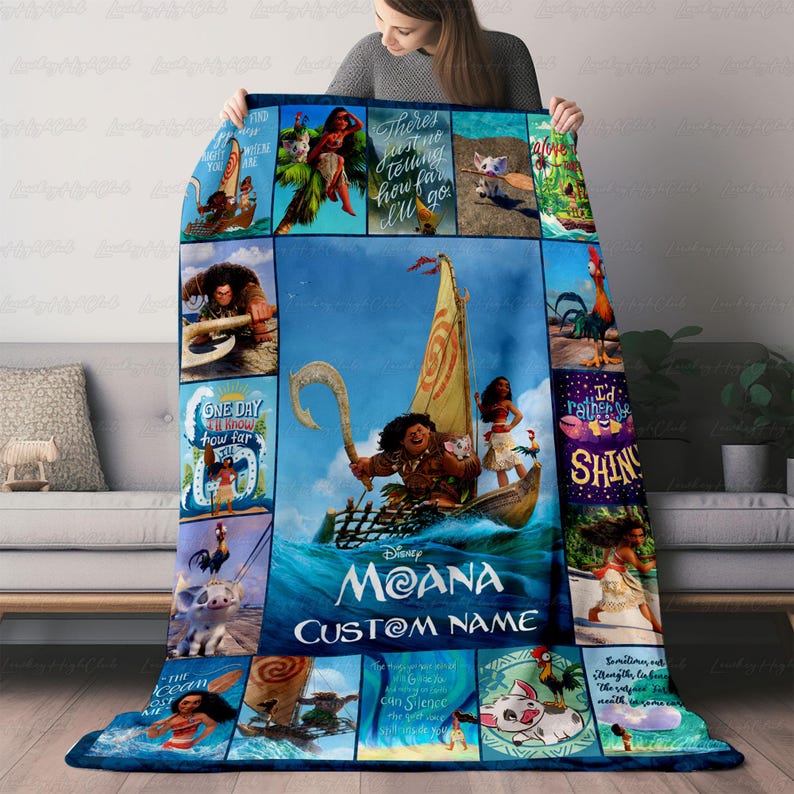 a woman is holding a blanket with a picture of moan