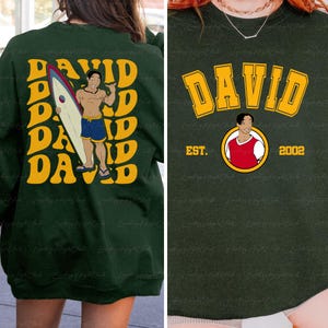 a woman wearing a green shirt with a picture of a man holding a surfboard