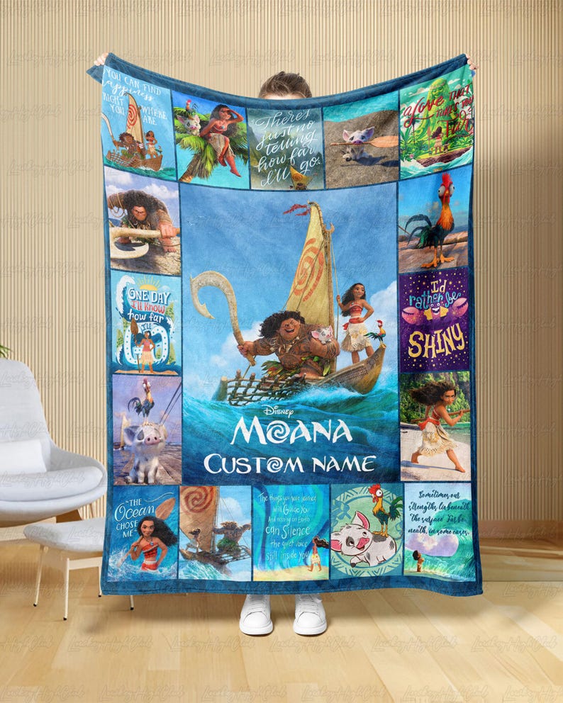 a man holding a blanket with a picture of moan on it