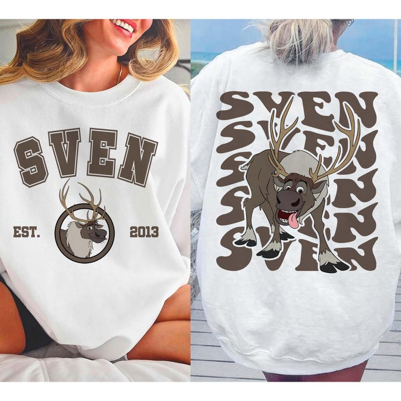 Pode incluir: Camisola branca com o nome "SVEN" em letras castanhas e um gr&aacute;fico de rena. O design frontal inclui "EST. 2013". A parte de tr&aacute;s apresenta um gr&aacute;fico de rena maior e o nome "SVEN" repetido num padr&atilde;o ondulado.