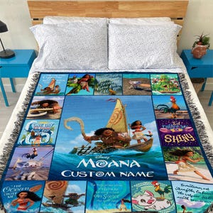 a bed with a blanket that has a picture of moan on it