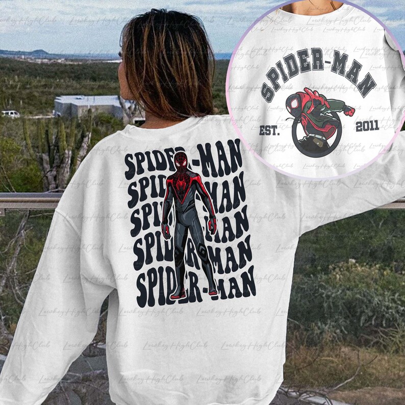 May include: White sweatshirt with a black and red Spider-Man graphic on the front. The graphic is repeated multiple times in a stacked pattern. The text "SPIDER-MAN" is written in black with a white outline. The text "EST. 2011" is written in black below the graphic.