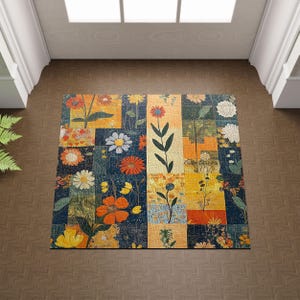 May include: A floral patterned rug with a patchwork design. The rug features a variety of colorful flowers in shades of orange, yellow, white, and blue. The rug is rectangular and appears to be made of fabric.
