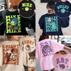 May include: A selection of graphic t-shirts and sweatshirts with cartoon character designs. The designs include "Mike" with a green eye, "Sulley" with a blue monster, "Knight" with a brown monster, and "Art" with a purple monster. Each design includes the year "2013".