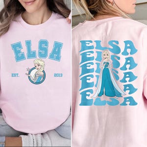 a woman wearing a pink shirt with a frozen princess on it