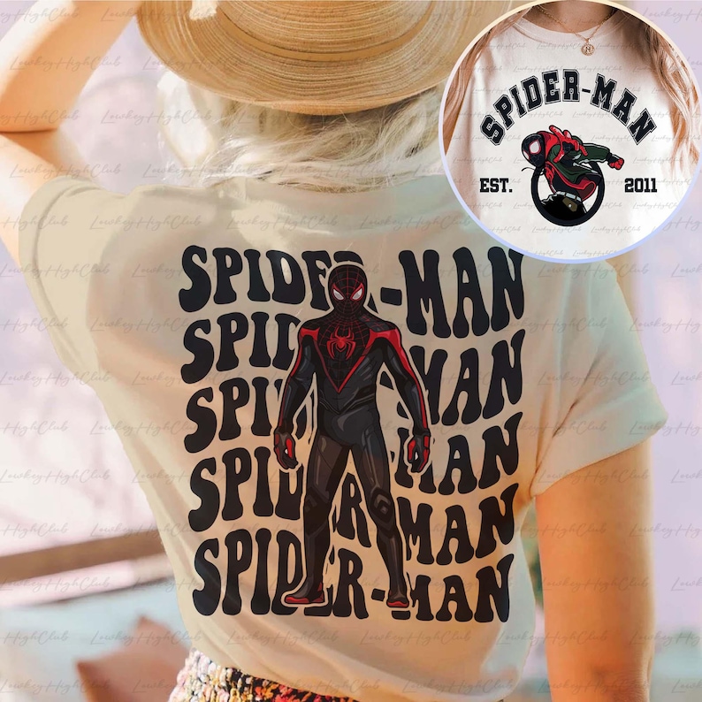 May include: A white t-shirt featuring a black and red Spider-Man graphic. The graphic is repeated several times in a retro style font. The text "SPIDER-MAN" is also printed on the shirt in a retro style font.