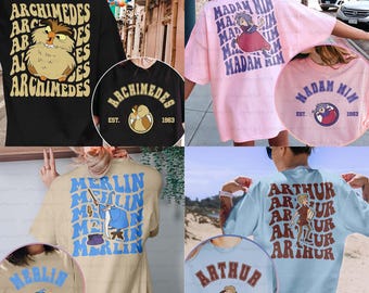 May include: Collection of t-shirts featuring cartoon characters and text. The shirts are in various colors, including black, pink, beige, and light blue. Each shirt has a different design, with characters like Archimedes, Madam Mim, Merlin, and Arthur. The text includes character names and the year 1963.