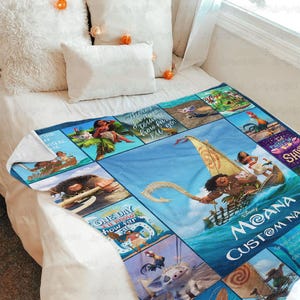 a bed with a blanket that has pictures on it