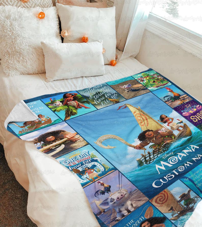 a bed with a blanket that has pictures on it
