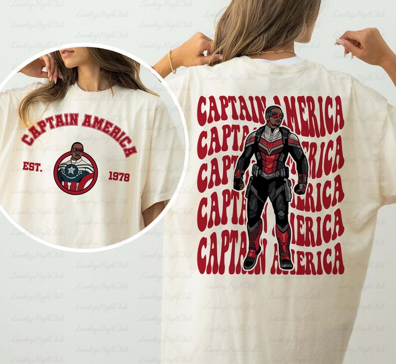 May include: Cream-colored t-shirt featuring Captain America graphics. The front displays "CAPTAIN AMERICA" in red arched text, with a circular emblem and "EST. 1978." The back showcases a Captain America figure with red text.