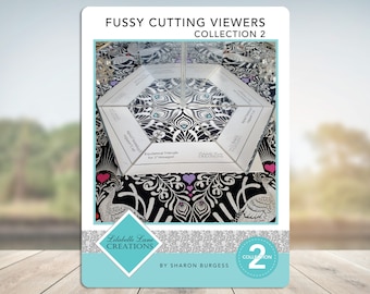 May include: A close-up of a clear acrylic fussy cutting viewer with a hexagonal base. The viewer is sitting on a black and white fabric with a peacock design. The text "Equilateral Triangle for 1" Hexagon" is printed on the viewer. The text "Libabelle Lane Creations" is also printed on the viewer. The text "Collection 2" is printed on the bottom right corner of the image.