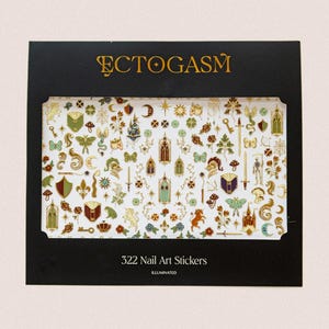 May include: A black box featuring 322 nail art stickers with various gold and white designs. The stickers include keys, shields, swords, and other fantasy-themed elements. The word "ECTOGASM" is printed in gold at the top.