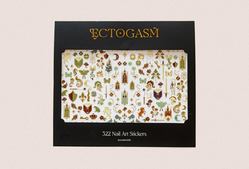 May include: A black box featuring 322 nail art stickers with various gold and white designs. The stickers include keys, shields, swords, and other fantasy-themed elements. The word "ECTOGASM" is printed in gold at the top.