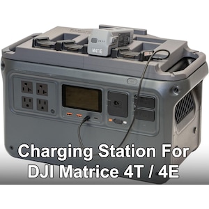 May include: A grey charging station for DJI Matrice 4T / 4E drones. It features multiple charging ports, power outlets, and a digital display. A drone battery sits on top. The text "Charging Station For DJI Matrice 4T / 4E" is displayed.