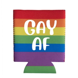 May include: A rainbow-striped can cooler with the text "GAY AF" in white. The cooler features a red top, transitioning through orange, yellow, green, blue, and purple stripes. The edges are stitched with a contrasting thread.