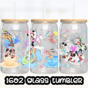May include: Three clear glass tumblers with wooden lids and straws. Each tumbler features a different Disney character design, including Mickey and Minnie Mouse, Goofy, and Dumbo. The text "16oz glass tumbler" is at the bottom.