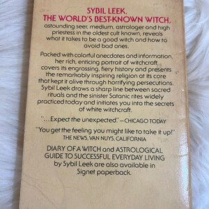 May include: The back cover of a vintage paperback book titled "The World's Best-Known Witch" by Sybil Leek. The cover is tan with black text, including quotes and a brief description of the book's contents.