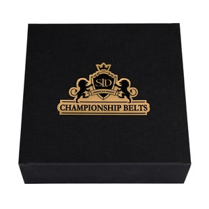 May include: A black box with a gold logo that says "SLD America's Finest Championship Belts".