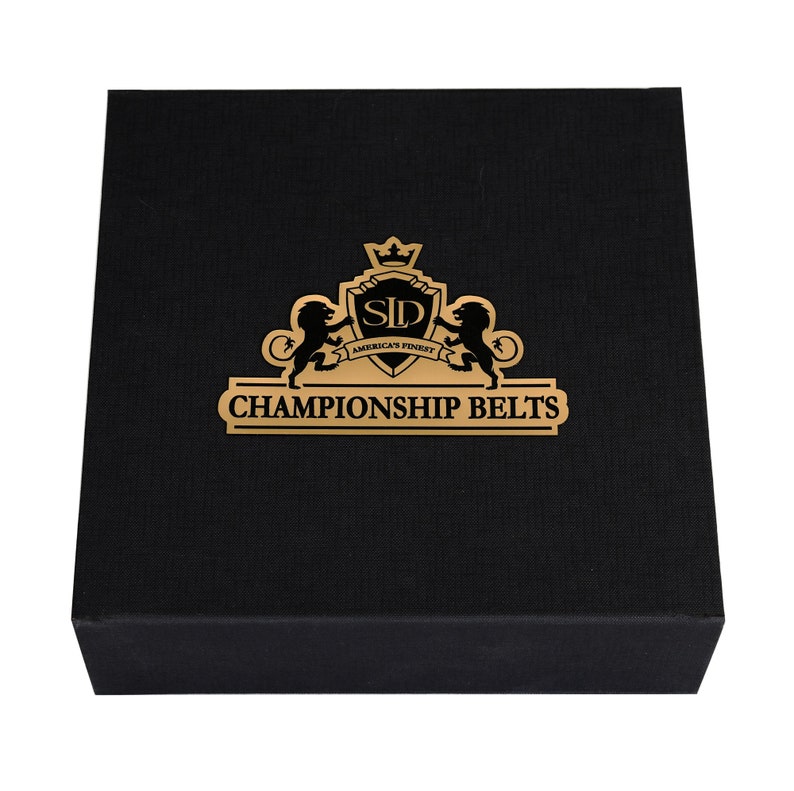 May include: A black box with a gold logo that says "SLD America's Finest Championship Belts".