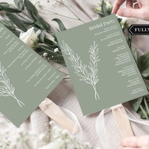 May include: Two sage green wedding fan programs with white floral illustrations and text. One fan reads "Allison + Graham" and the wedding date. The other fan reads "Bridal Party". Both are fully assembled.