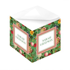 May include: A green and pink floral notepad with the name "SARAH GRAYSON" printed on the front.