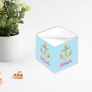 May include: Personalised stationery set with a blue and white chequered pattern. It features a floral anchor design and the name "Michaela" in pink script. The stationery is displayed with a small potted plant and rose gold paper clips.