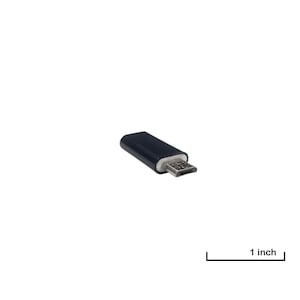 May include: A black Micro USB to USB adapter. The adapter is approximately 1 inch long. The connector end is silver, and the body is a solid, dark color. The adapter is designed to connect devices.