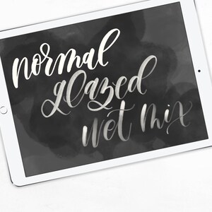May include: A white chalk board with the words "normal glazed wet mix" written in white chalk.