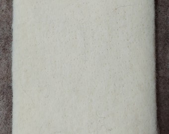 May include: A white felt square, possibly for crafting or other uses.