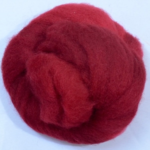 May include: A close-up of a ball of deep red wool fiber. The wool is soft and fluffy, and it is perfect for felting or spinning.