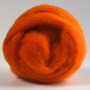 May include: A ball of orange wool roving, a type of fiber used for felting and spinning.