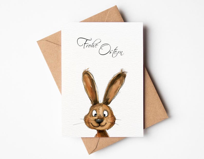 Ostergrußkarte mit charmantem Design: Niedliches Aquarellmotiv eines Hasen, der neugierig über den Rand blickt, kombiniert mit dem handschriftlichen Schriftzug 'Frohe Ostern'. Die Karte strahlt Frühlingsfreude aus, perfekt, um Ihren Osterwünschen eine besondere Note zu verleihen