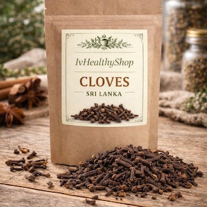 May include: A brown paper pouch containing dried cloves, featuring a white label with the text IvHealthyShop, CLOVES, and SRI LANKA. A pile of dark brown, whole dried cloves sits in front of the pouch on a wooden surface.
