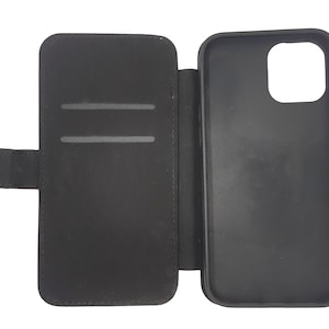 May include: Black leather phone case with a flap that folds over the screen. The case has a slot for credit cards or ID.