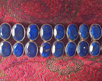 Lapis Lazuli bracelet 76 grams silver set. Heavy oval faceted 22.5cm in length x 2.7cm in width x 5mm deep. Marked 925.