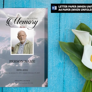 May include: A white dove with outstretched wings flies through a cloudy sky. The text "In Loving Memory" is written in a black cursive font. A photo of a man is in a white frame below the text. The text "Person Name" is below the photo. The dates "1970-2015" are below the name. The text "Sunrise: January 01, 1970 | Sunset: February 27, 2017" is below the dates. The text "Amazing Church" is below the dates. The text "123 street, 321 NewYork, NY, USA" is below the church name.