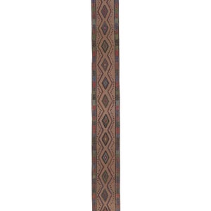 May include: A long, narrow rug with a brown background and a colorful geometric pattern. The pattern features diamonds, triangles, and other shapes in shades of red, blue, green, and yellow.