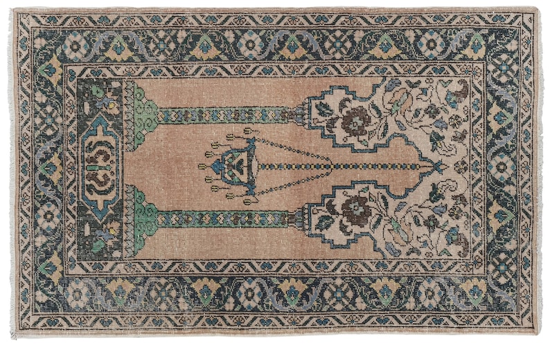 May include: A vintage prayer rug with a beige background and a central design featuring a chandelier with hanging lights. The rug has a blue, green, and black border with floral patterns.