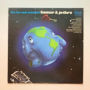 May include: Vinyl record album cover art featuring a cartoon Earth with a sad expression. The album is titled "The Far-Out World of Homer & Jethro" and features a list of songs on the back cover. The album is by RCA Victor.