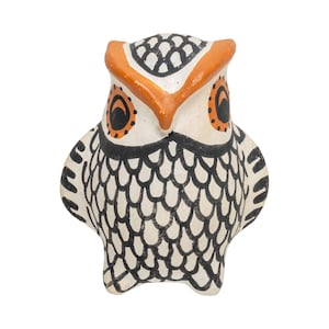 May include: A ceramic owl figurine with a white body, black markings, and orange accents. The owl has large, round eyes and a detailed feather pattern. The figurine is a decorative item.