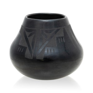 May include: A black pottery vase with a geometric design. The vase is hand-crafted and has a smooth, matte finish.