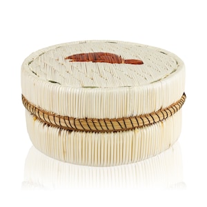 May include: A round, woven basket made of natural materials with a brown woven design on the top. The basket is white with a brown woven band around the middle.