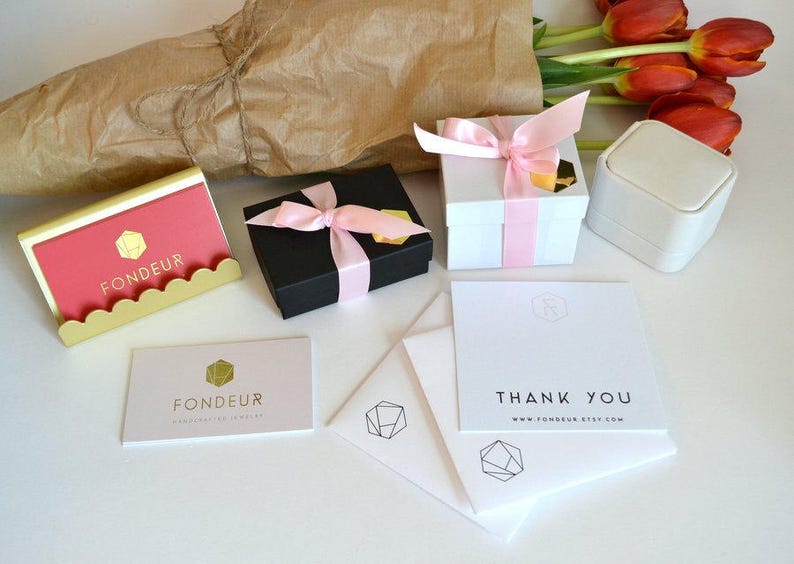 K&ouml;nnte beinhalten: Eine wei&szlig;e Box mit einem rosa Band und dem Text "FONDEUR" auf der Vorderseite. Die Box steht auf einer wei&szlig;en Oberfl&auml;che mit einer Dankeskarte, auf der "DANKE www.fondeur.etsy.com" steht.