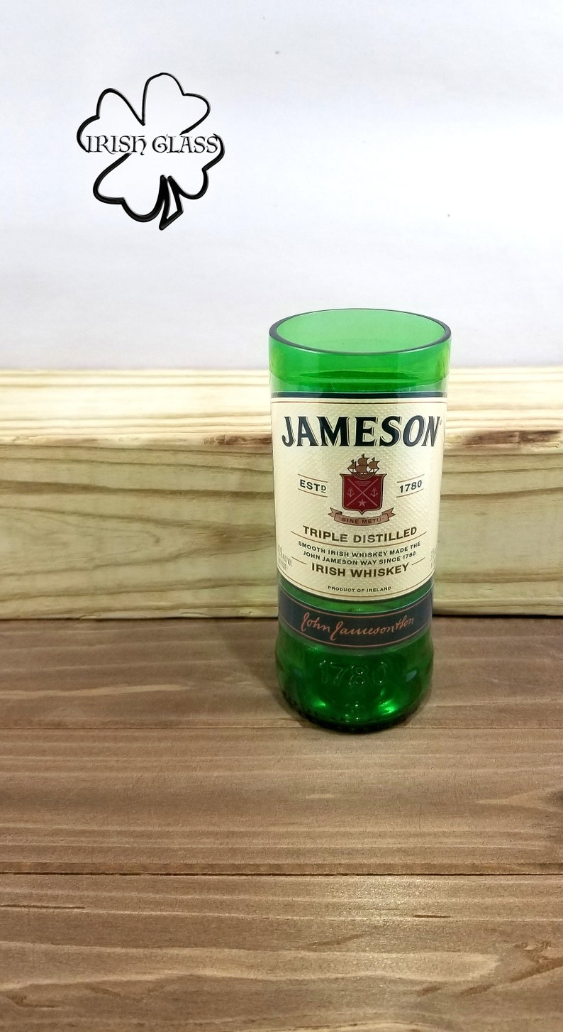 May include: A green glass bottle of Jameson Irish Whiskey. The bottle has a label with the Jameson logo and the text "Triple Distilled" and "Irish Whiskey".