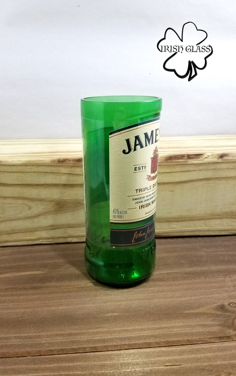 May include: A green glass bottle with a label that reads "JAMESON ESTD TRIPLE DISTILLED SMOOTH IRISH WHISKEY JOHN JAMESON & SON IRISH WHISKEY PRODUCT OF IRELAND John Jameson & Son"