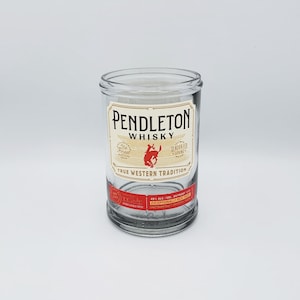 May include: Clear glass tumbler with a label that reads "Pendleton Whisky" with a red bucking bronco logo. The glass has a cylindrical shape and is designed for spirits. The words "Irish Glass" are above the glass.