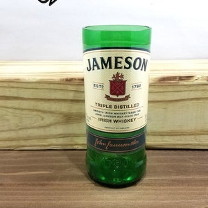 May include: A green glass Jameson Irish Whiskey bottle with a white label featuring the Jameson logo and the text "ESTD 1780", "TRIPLE DISTILLED", "SMOOTH IRISH WHISKEY MADE THE JOHN JAMESON WAY SINCE 1780", "IRISH WHISKEY", "PRODUCT OF IRELAND", and "John Jameson & Son".