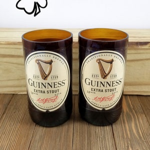 May include: Two brown glass Guinness beer bottles with the Guinness logo and text "Traditionally Brewed", "Est. 1759", "Guinness", "Extra Stout", "5.6% Alc./Vol.", "11.2 fl. oz.", "St. James's Gate Dublin", and "Arthur Guinness" printed on the label.