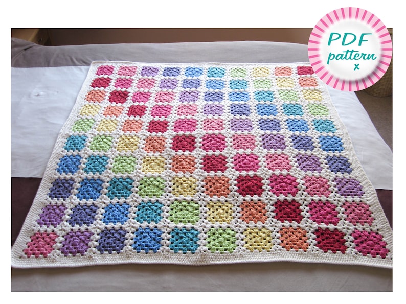 May include: A rainbow crochet blanket with a white background and a PDF pattern download available. The blanket is made up of squares in various shades of pink, red, orange, yellow, green, blue, purple, and white.