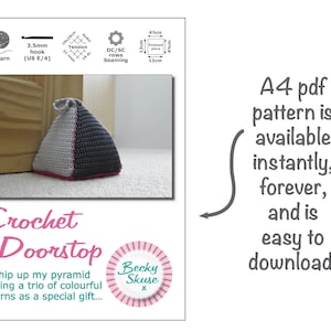 May include: A crochet doorstop in the shape of a pyramid. The doorstop is made with three colors of yarn: gray, white, and pink. The doorstop is sitting on a white carpet next to a wooden door. The text "Crochet Doorstop" is written in cursive below the doorstop. The text "Whip up my pyramid using a trio of colorful yarns as a special gift..." is written below the text "Crochet Doorstop". The text "Becky Skuse" is written in a circle with a pink and white striped pattern below the text "Whip up my pyramid using a trio of colorful yarns as a special gift...". The text "A4 pdf pattern is available instantly, forever, and is easy to download." is written on the right side of the image.